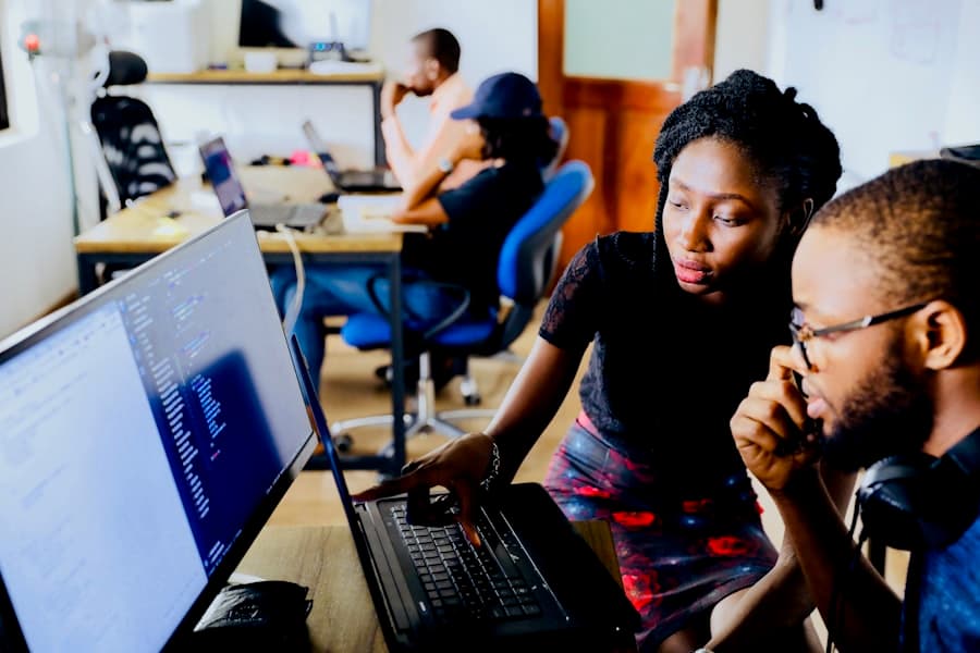 Two developers pair-programming at a laptop