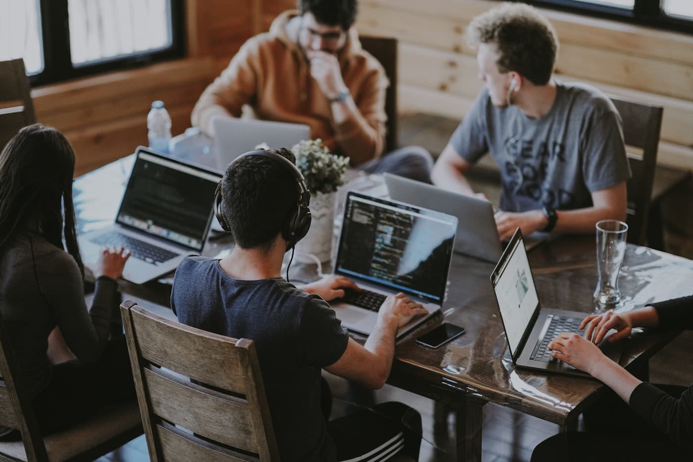 An agency team collaborating over laptops